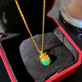 Close-up of a gold cat pendant necklace featuring a green imitation jade bead in a gift box - Cat Green Bead (W1195-1)