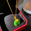 Close-up of a green Ruyi faux jade pendant necklace presented in a red gift box. - Fu Character Ping'an Buckle (W1199)
