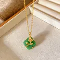 Detail shot of a green clover pendant necklace with a gold rose motif in a jewelry tray - Rose Four-Leaf Clover Style (W200)