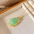 Close-up view of a gold-plated necklace with a green Buddha pendant in a luxury jewelry tray. - Diamond-Inlaid Maitreya Buddha Style (W248)