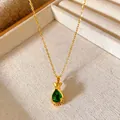 Detailed view of golden titanium steel necklace with green lucky bag pendant in a tray - Money Bag Water Drop Green Stone Style (W250)
