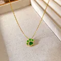 Detailed macro view of a gold-plated cat paw pendant necklace with green inlay - Cat Paw Gem Style (W265)