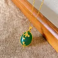 Close-up of a vintage Chinese style necklace featuring an elegant green oval pendant - Oval Branch Floral Style (W286)