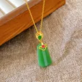 Detail of a vintage Chinese style necklace with a gold chain and green jade-like pendant - Auspicious Cloud Trapezoid Jade Style (W1101)