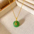 Close-up of a green doughnut jade pendant with a golden coin accent on a dainty chain. - Square Hole Coin Pingan Buckle Style (W1102)