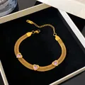 Detailed macro view of the gold mesh bracelet with heart-shaped pink crystal gems - Gold-Pink Zirconia Heart Mesh Bracelet