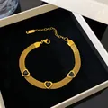 Detailed view of gold titanium steel mesh bracelet with black heart charms in a box. - Gold-Black Zirconia Heart Mesh Bracelet
