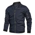 Detailed view of a navy blue men's bomber jacket with ribbed collar and sleeve pocket. - M / Tops / Dark Blue