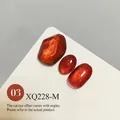 Amber cat-eye nail gel swatch in warm reddish-orange tone with high-density glass bead shimmer - Caramel Amber (XQ228-M)