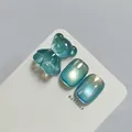 Teal blue cat-eye nail gel swatch with a cute gummy bear charm and shimmering finish - High Density Glass Bead Cat Eye Style (XQ100-M) / Cyan Blue Cat Eye
