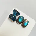 Teal cat-eye nail gel swatch with 3D bear charm, variant XQ212-M professional finish - Blue-Green Polarized Cat Eye (XQ212-M)