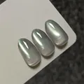 Premium green cat-eye magnetic nail polish gel with shimmer effect on white display card - Pale Green Polarized Cat Eye (XQ62-M)