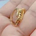 Close-up of gold-plated open ring featuring micro-pave cubic zirconia and unique geometric spikes. - Style D (Geometric Screw)
