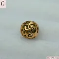 Macro view of a gold stainless steel filigree hollow bead, measuring 10.4x9.7mm. - Gold (G)