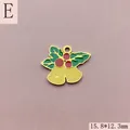 Close-up of golden enamel Christmas bells charm with holly leaves and red berries for DIY - Style E