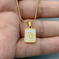 Macro detail of Virgo zodiac symbol engraved on a gold stainless steel shell pendant. - Virgo