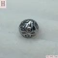 Macro view of a retro silver hollow stainless steel scroll pattern bead for DIY jewelry making - Antique Silver (Style H)