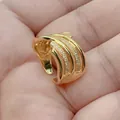 Macro detail of a gold-plated geometric hollow fan ring with shimmering micro-pave CZ stones - Style H (Micro Inlaid Fan)