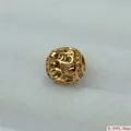 Macro detail of vintage gold hollow stainless steel round charm bead for DIY jewelry - Gold (K)