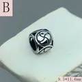 Macro view of vintage stainless steel large hole spacer bead with swirl pattern engraving - Geometric Vortex Pattern (B) / 9.5x11.6mm