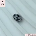 Detailed macro shot of vintage silver filigree spacer bead, size 4.2x9.2mm for DIY jewelry - Hollow Scroll Pattern (A) / 4.2x9.2mm