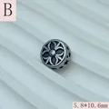 Detailed macro view of a vintage style stainless steel star spacer bead for DIY jewelry - Hollow Flower Pattern (B) / 5.8x10.6mm