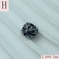 Detailed close-up view of vintage silver stainless steel bead with intricate cross engraving - 7.6x9.7mm