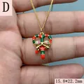 Close-up detail of gold Christmas candy cane heart pendant with a colorful zircon bow - Candy Cane Heart Style (D) / Gold