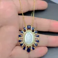 Detail view of the Virgin Mary Guadalupe necklace with shell pendant and blue stones. - Guadalupe