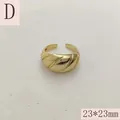 Detailed macro shot of a chunky gold twisted croissant ring with 23x23mm size label. - French Twist Croissant Style (D) / 23x23mm / Gold