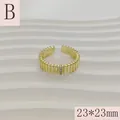 Detailed macro shot of a vintage gold-toned ribbed open ring with small inlaid stones - Triple Zirconia Crown Style (B) / 23*23mm (Adjustable Open) / Gold