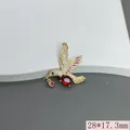 Macro detail of gold hummingbird pendant inlaid with red and pink zircons, 28x17.3mm - Red