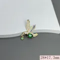 Detailed view of gold hummingbird pendant with blue and green micro-pave zircons - Green