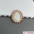 Detailed view of a gold-plated religious cross pendant with pink zircons and white shell relief - Rose Red