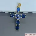 Detailed macro view of a gold-plated religious cross pendant featuring blue zircon stones - 19.2x30mm / Blue