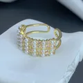Close-up of elegant gold-plated ring with three rows of pearls and zircon stones - Three-Row Pearl Zirconia Pave Style