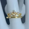 Macro shot of an elegant gold crown ring featuring hollow heart designs and zircons. - Hollow Heart Crown Style (B)