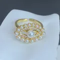 Exquisite close-up of gold-plated evil eye ring adorned with white pearls and zircons - Evil Eye Pearl Border Micro-Inlaid Style