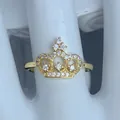 Primo piano di un lussuoso anello a corona dorato con zirconi scintillanti di classe. - Stile Corona Cava Splendida (H)