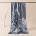 Close-up of luxury snowflake satin silk scarf featuring artistic large floral print pattern - Lotus in Bloom / 53x192cm