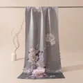 Detailed view of peony floral pattern and side button closure on grey satin silk shawl - Peony Bloom Blue Purple / 53x192cm