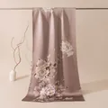 Detailed view of elegant Chinese style silk shawl with peony flower pattern and buttons - Peony Bloom Green / 53x192cm