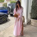 Model wearing a French-style pink oversized long shirt dress with a high side slit - One Size / Pink