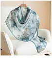 Elegant mulberry silk scarf featuring a teal floral print draped on a white armchair - 170x55cm Gift Box Set / Blue Green Jacquard Magnolia