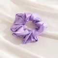 Elegant purple satin silk scrunchie hair tie for women on soft white fabric background - L / Purple