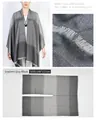 Detailed view of grey gradient poncho showing fabric texture and 148x117cm size dimensions. - Gradient Grey Black
