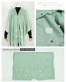 Detail view of light green poncho with pearl and faux fur ball embellishments - Light Green with Artificial Pearls
