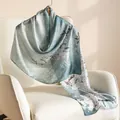 Elegant light blue mulberry silk scarf with white floral print on a chair - 55x170cm / Winter Plum Blossom (FHZ25-9578-1)