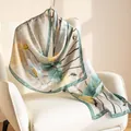 Elegant mulberry silk scarf featuring a green lotus and koi fish pattern print. - 55x170cm / Jade Lotus (FHZ25-9585-1)