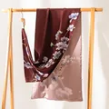 Elegant burgundy pure silk scarf with magnolia floral print displayed on a wooden rack - 170x55cm / Wine Red Floral Vine (FHZ24-9390-1)